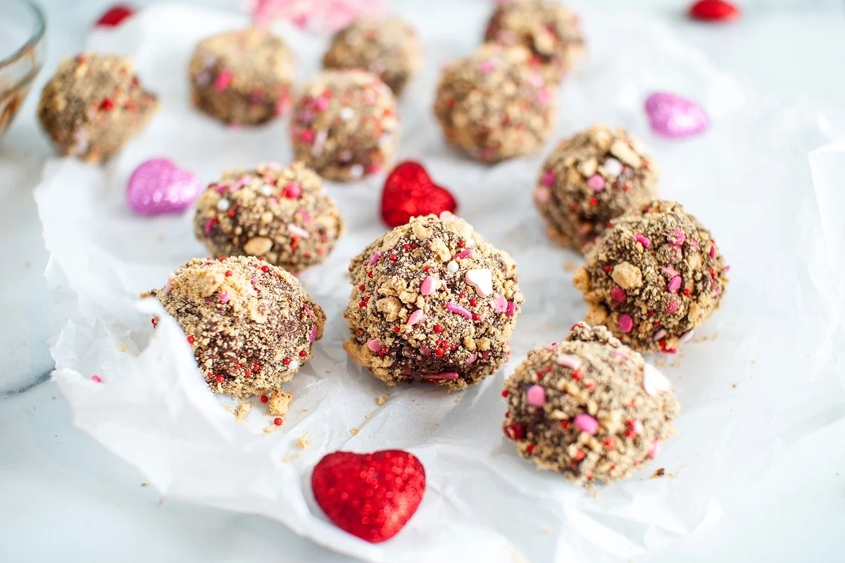Valentine's Day desserts, chocolate truffles on a white sheet of paper.