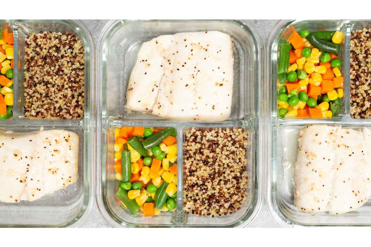 Four healthy lunch containers with high protein fish and vegetables.