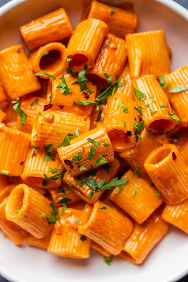 A quick and easy bowl of pasta with sauce and parsley.