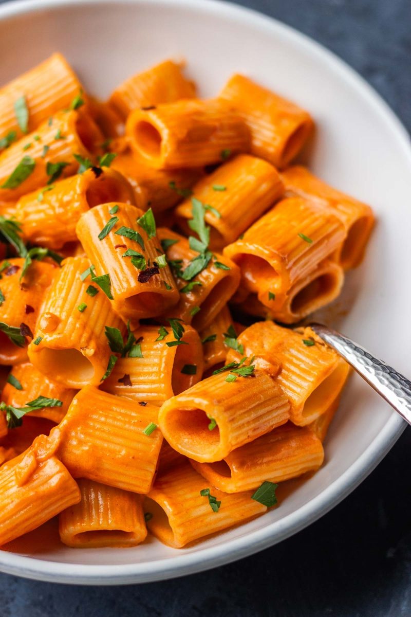 Gigi Hadid's pasta recipe features a mouthwatering bowl of pasta topped with sauce and parsley.