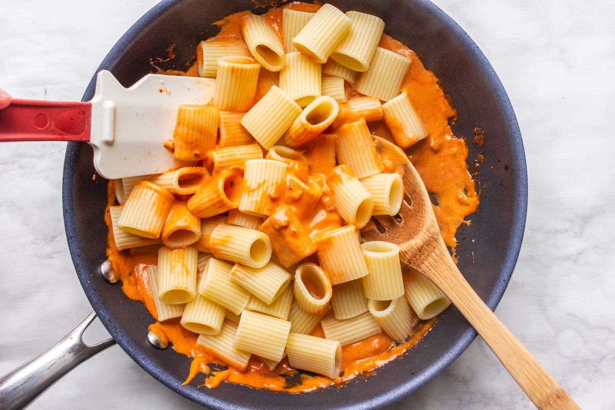 Gigi Hadid's famous pasta recipe cooked in a pan with sauce and a spatula.