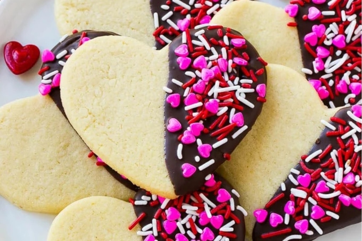 Valentine's Day cookies with chocolate and sprinkles displayed on a plate.