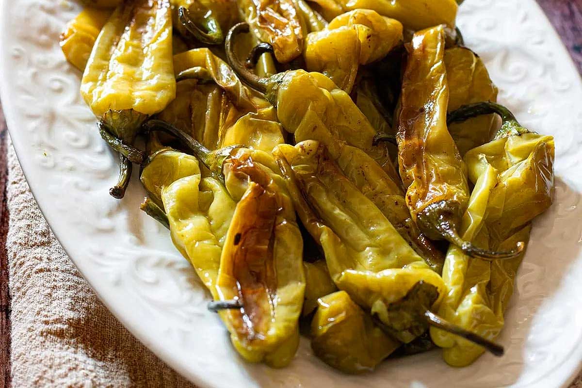 Italian roasted peppers on a white plate.
