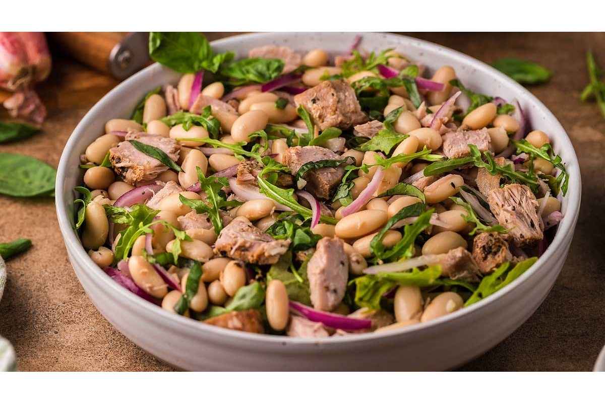 Healthy lunch option: White bean and pork salad, packed with high protein, served in a white bowl.