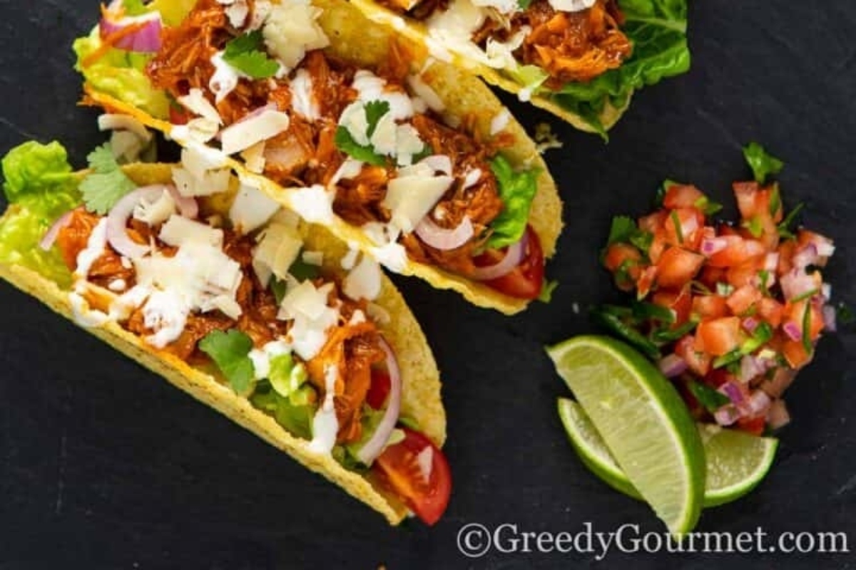 Easiest chicken tacos on a black plate.