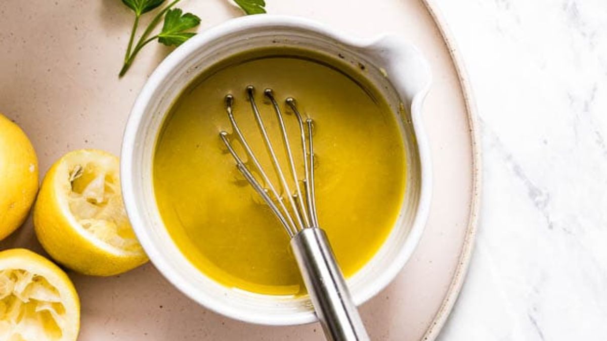 bowl with whisk and lemon dressing.