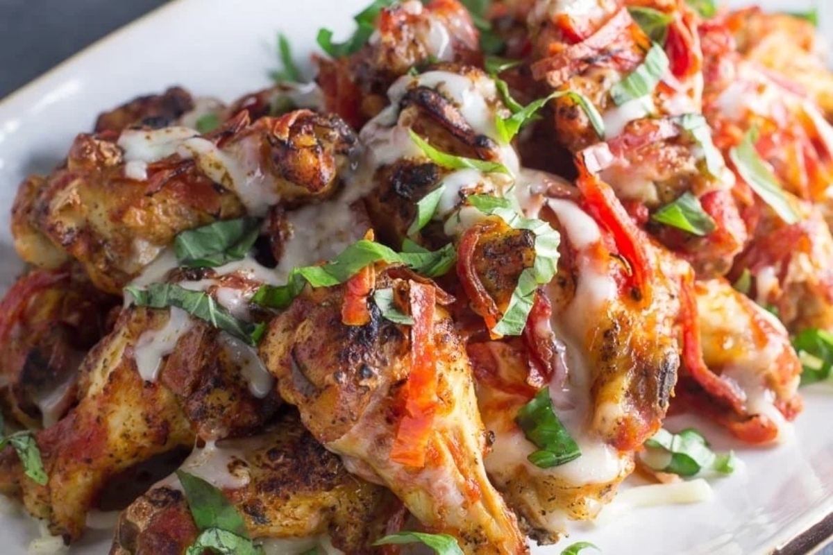 Game Day Recipes: A plate of chicken wings with sauce on it.