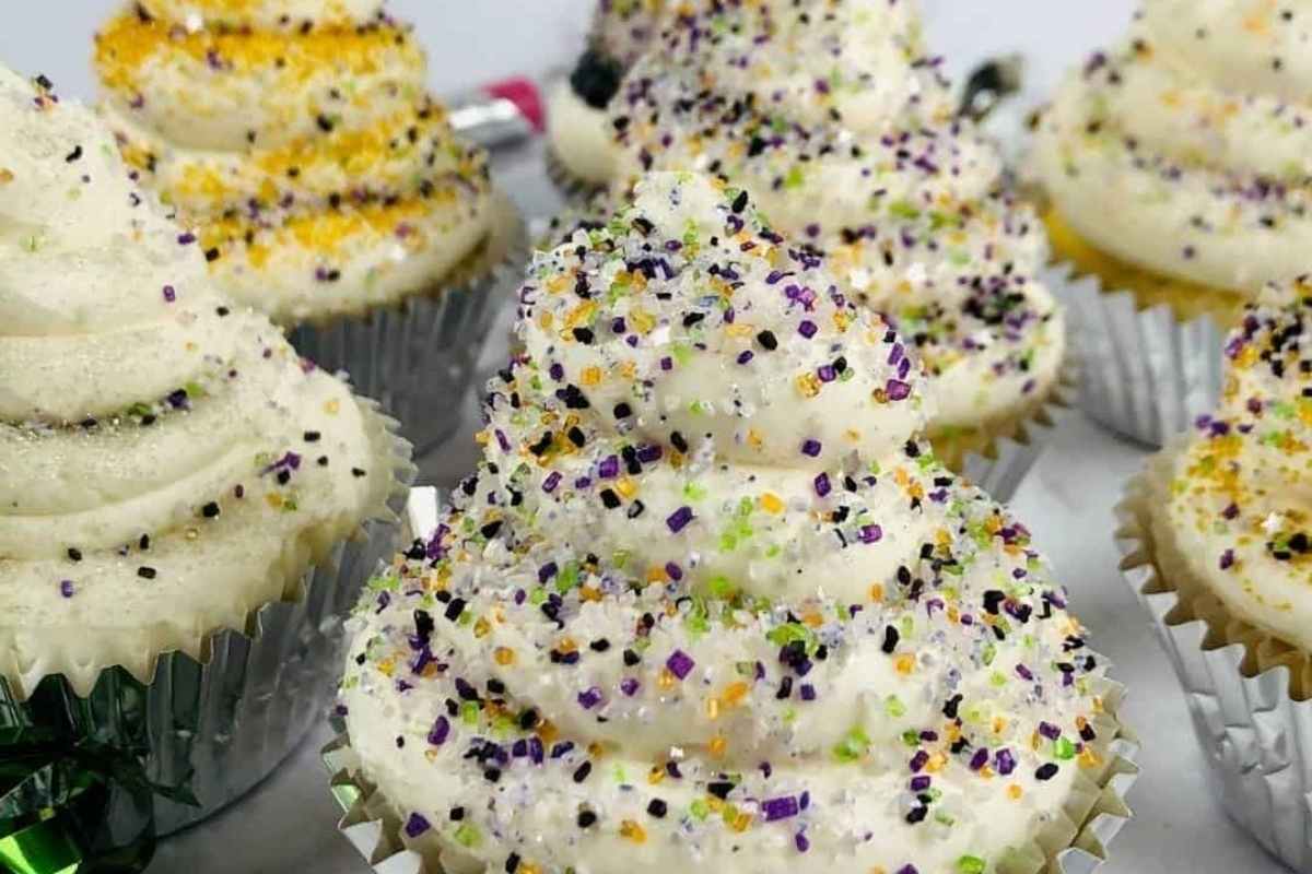 A group of cupcakes decorated with sprinkles and icing.