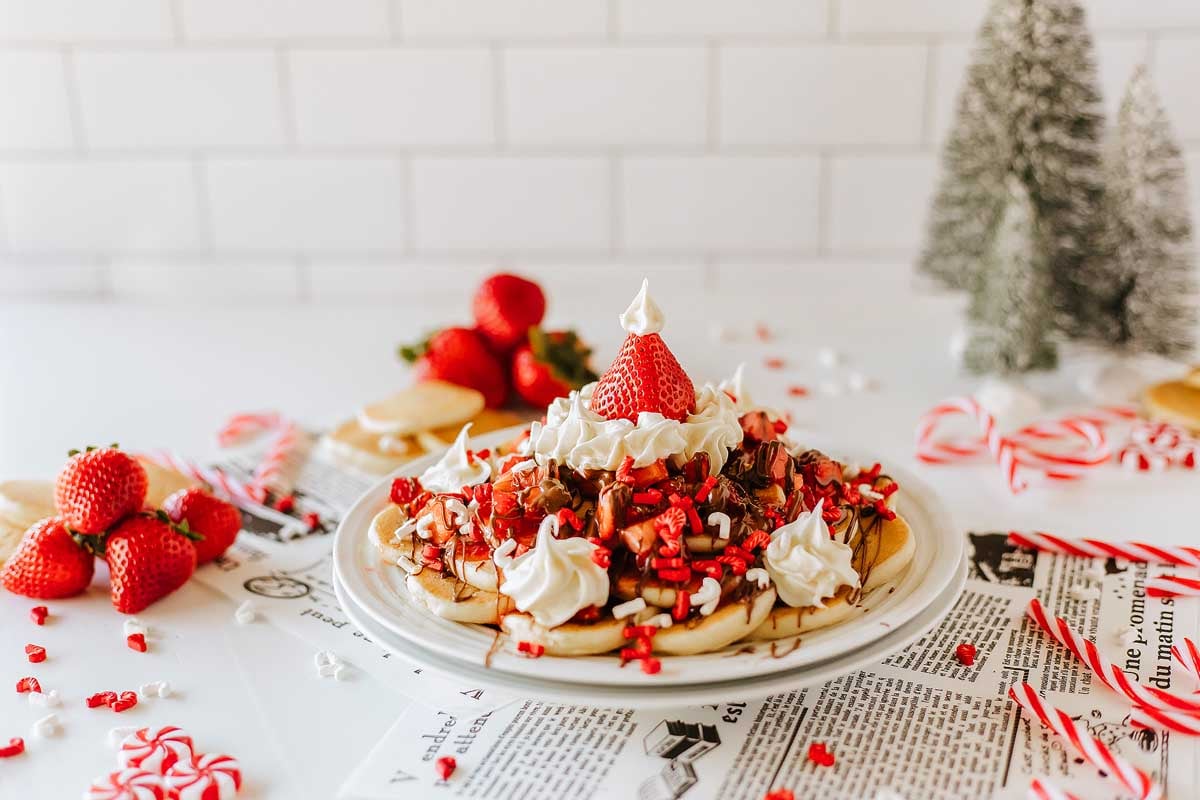A festive plate with a santa hat and candy canes, perfect for serving up Christmas breakfast recipes.