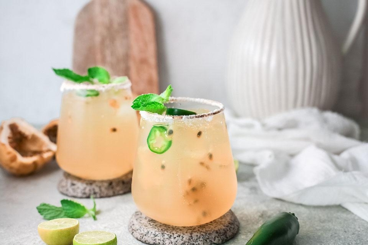 Two Valentine's Day cocktails - jalapeno margarita with lime and mint.