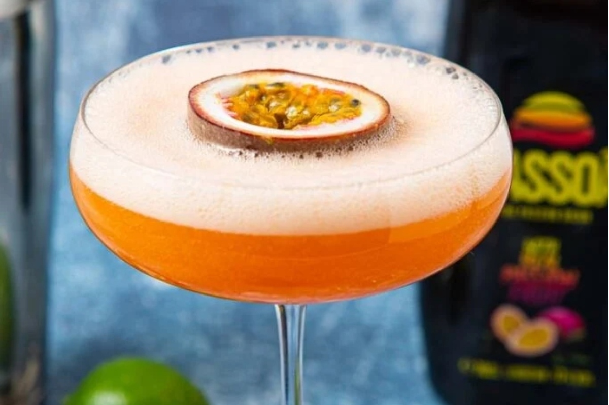 A Valentine's Day cocktail with a passion fruit in the glass.