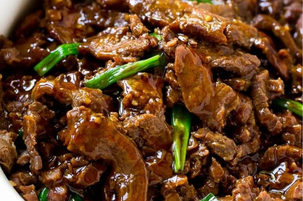 A bowl of beef in a brown sauce.