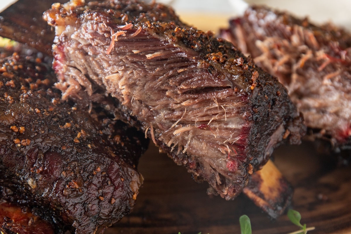 Winter-inspired BBQ beef ribs on a wooden cutting board.