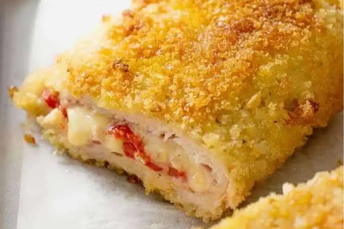 Cheese-stuffed chicken on a baking sheet.