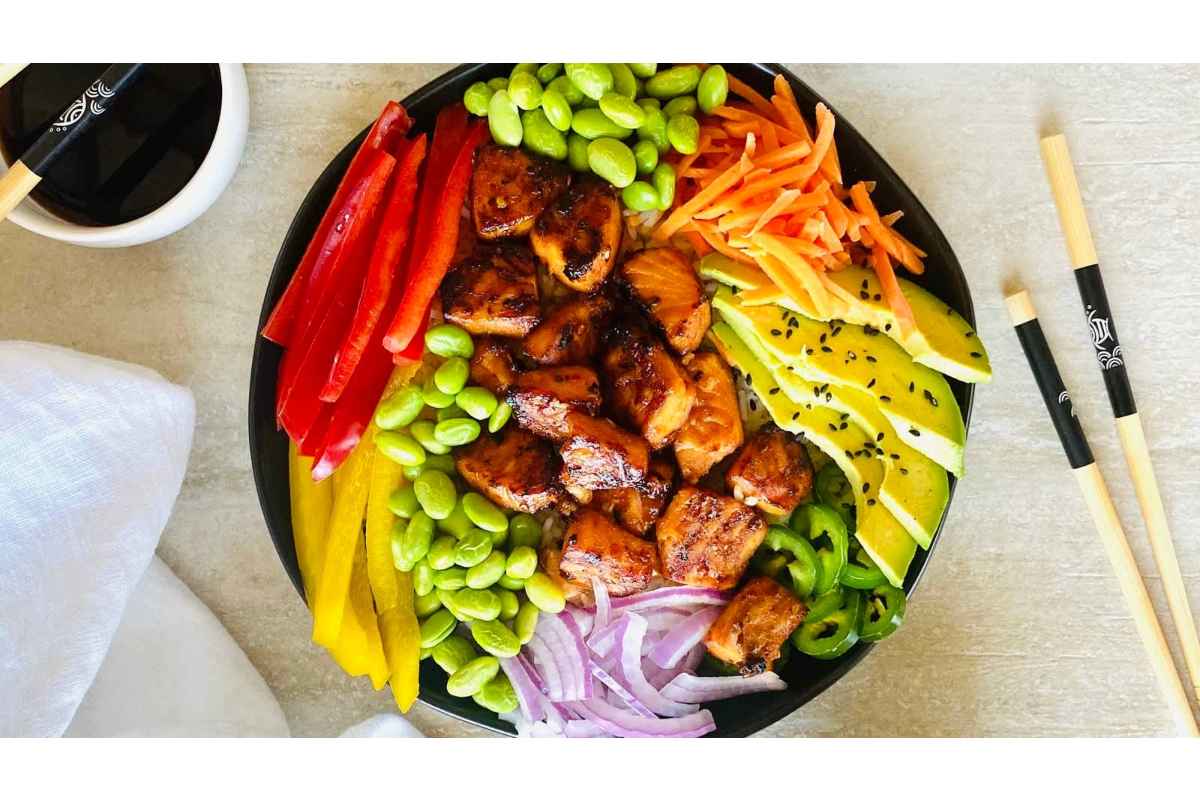 45 Healthy High Protein Lunches - A bowl of asian chicken salad with vegetables and chopsticks.