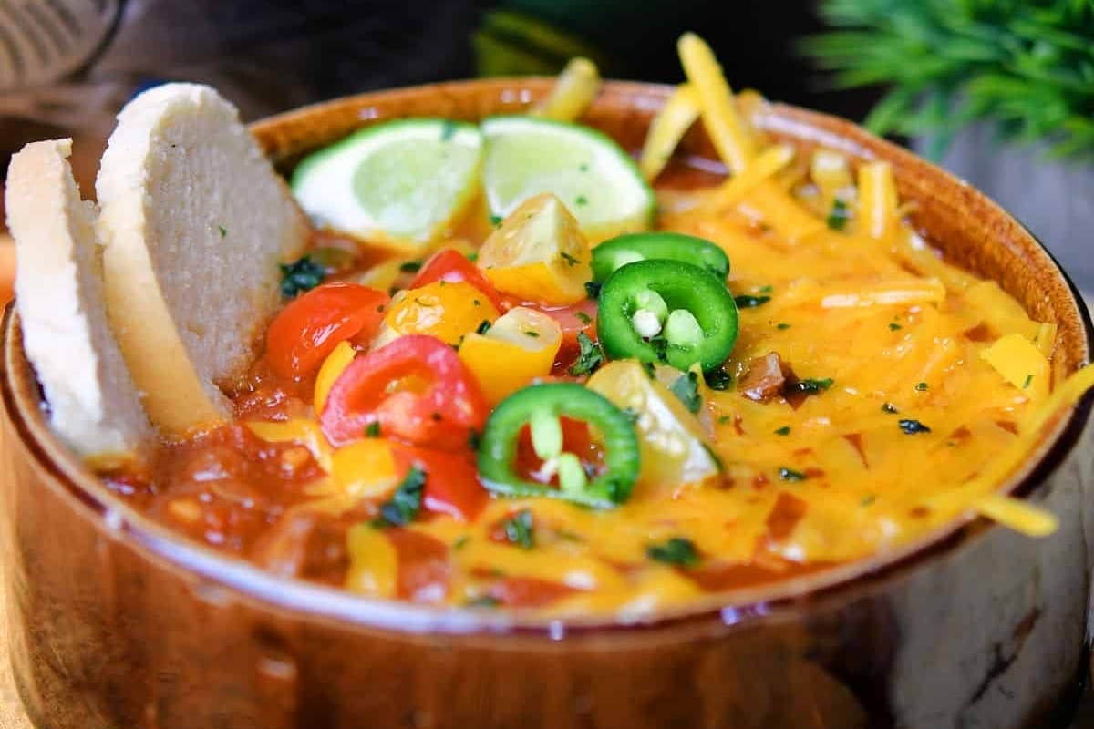 A slow cooker chili served in a wooden bowl.