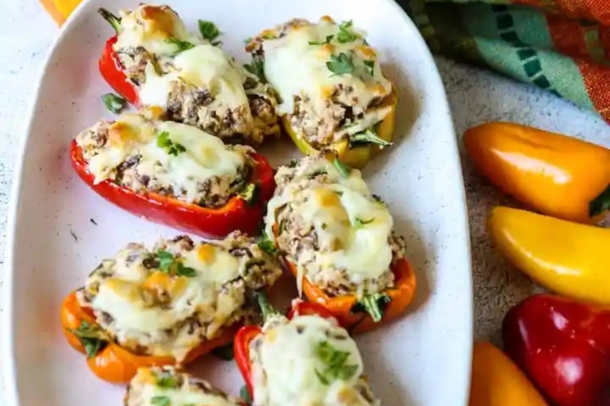 Easiest stuffed peppers recipe for Game Day, served on a white plate with meat and cheese.