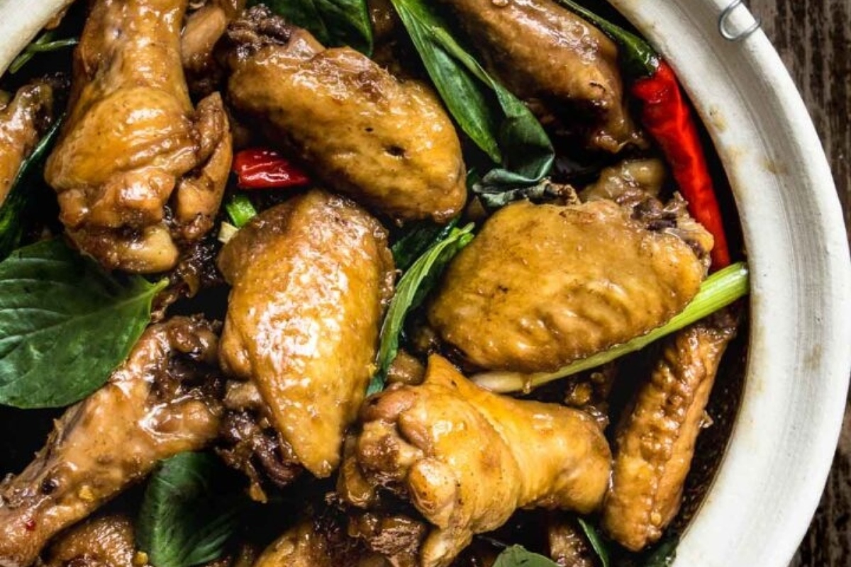 Winter chicken dinners in a white bowl on a wooden table.