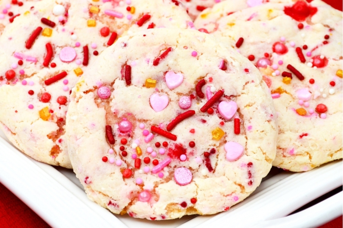 Valentine's Day cookies with sprinkles on a plate.