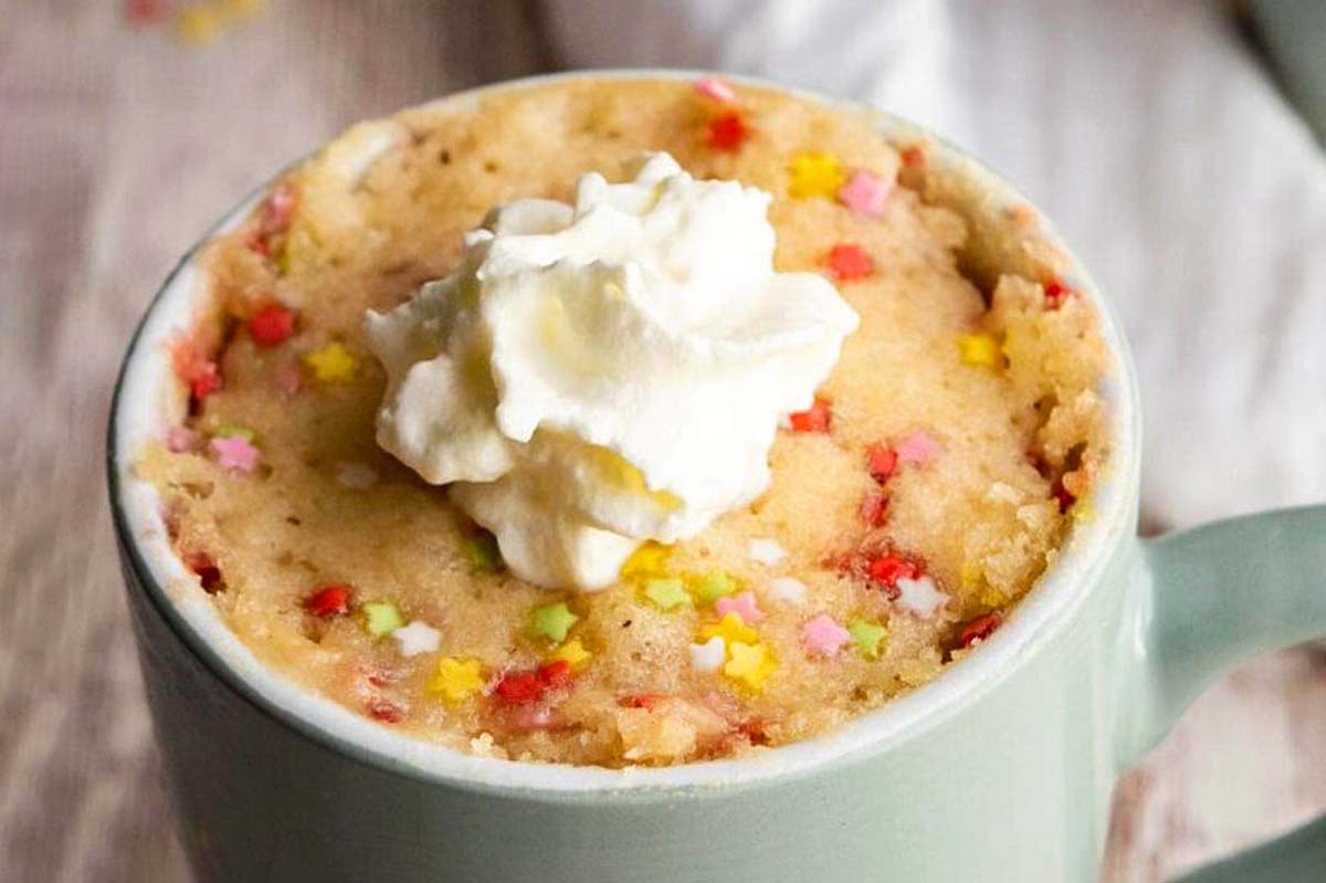         Mug cake recipes featuring cupcakes in a mug with whipped cream and sprinkles.