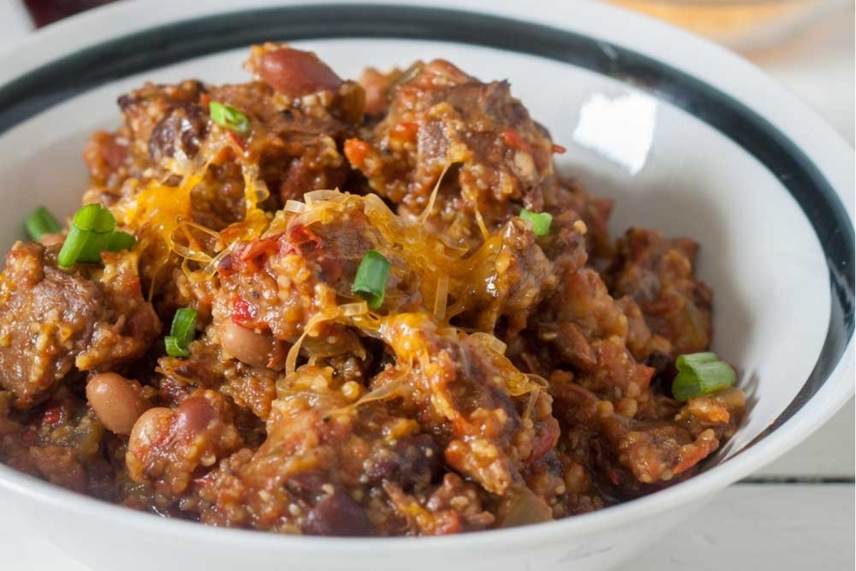 Slow Cooker Chili in a bowl on a wooden table.