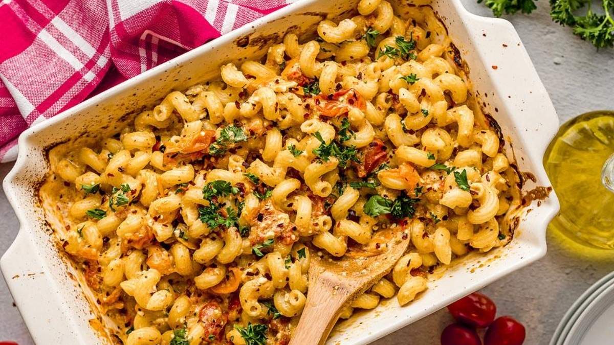A comforting dish of macaroni and cheese, elevated with the addition of tomatoes and flavorful herbs.