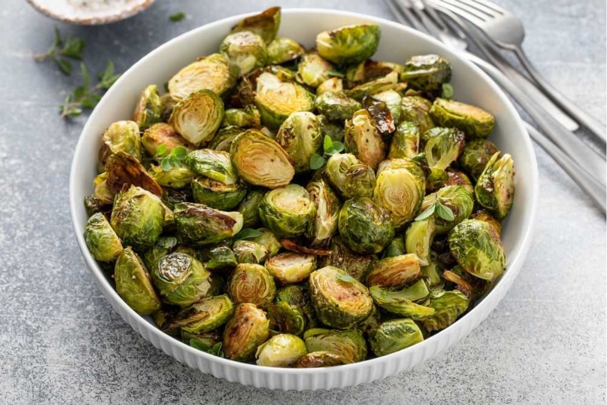 Roasted brussels sprouts in a white bowl.