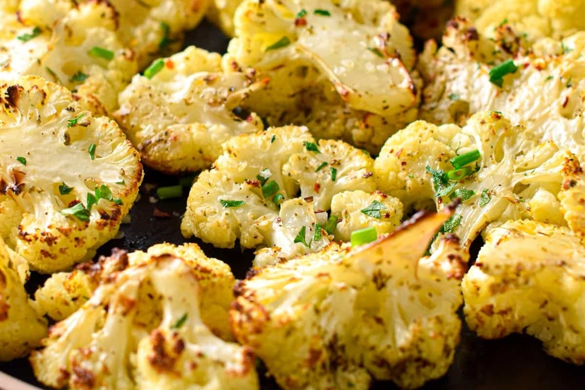 Cauliflower florets on a baking sheet.