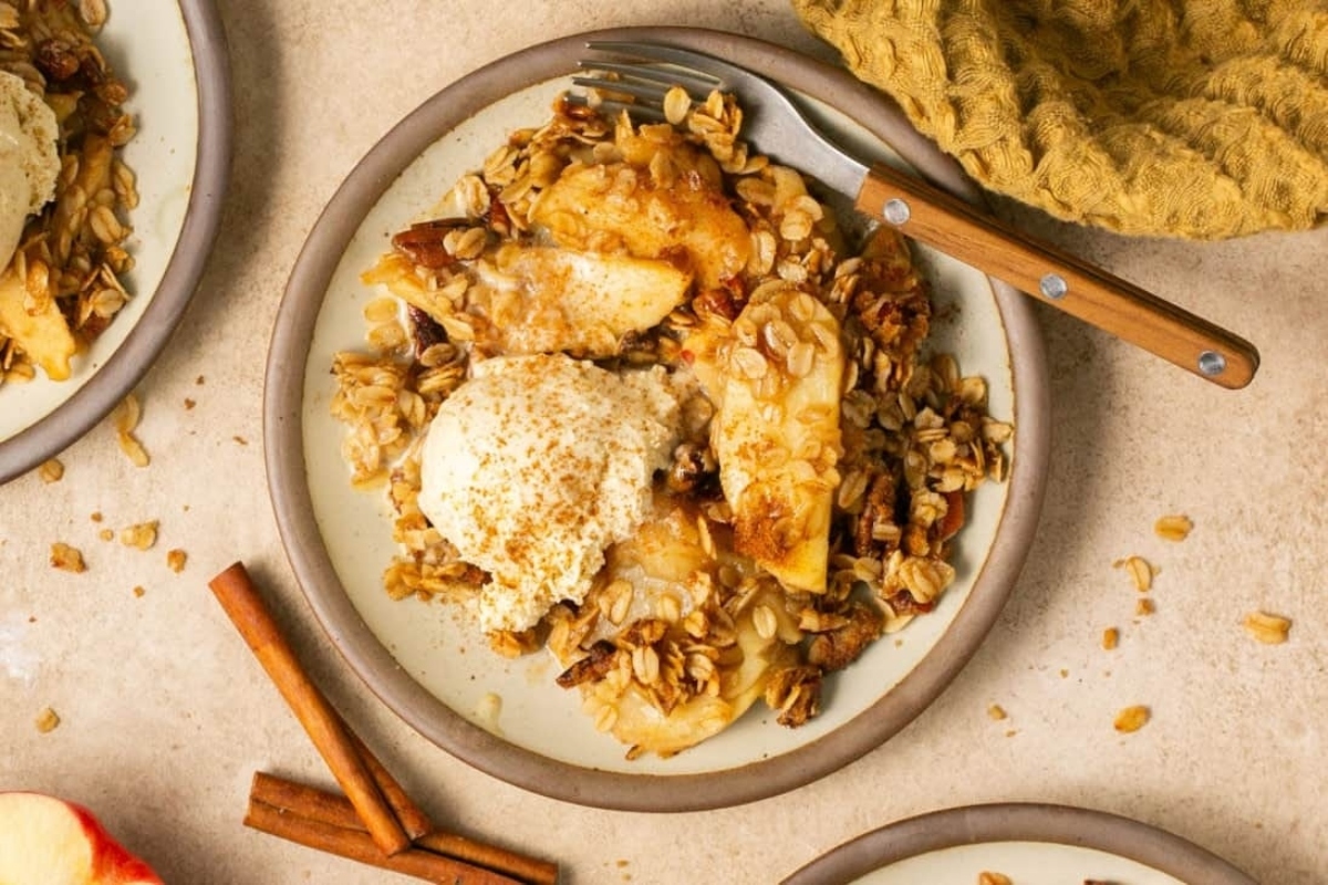 A plate of granola with apples and cinnamon.