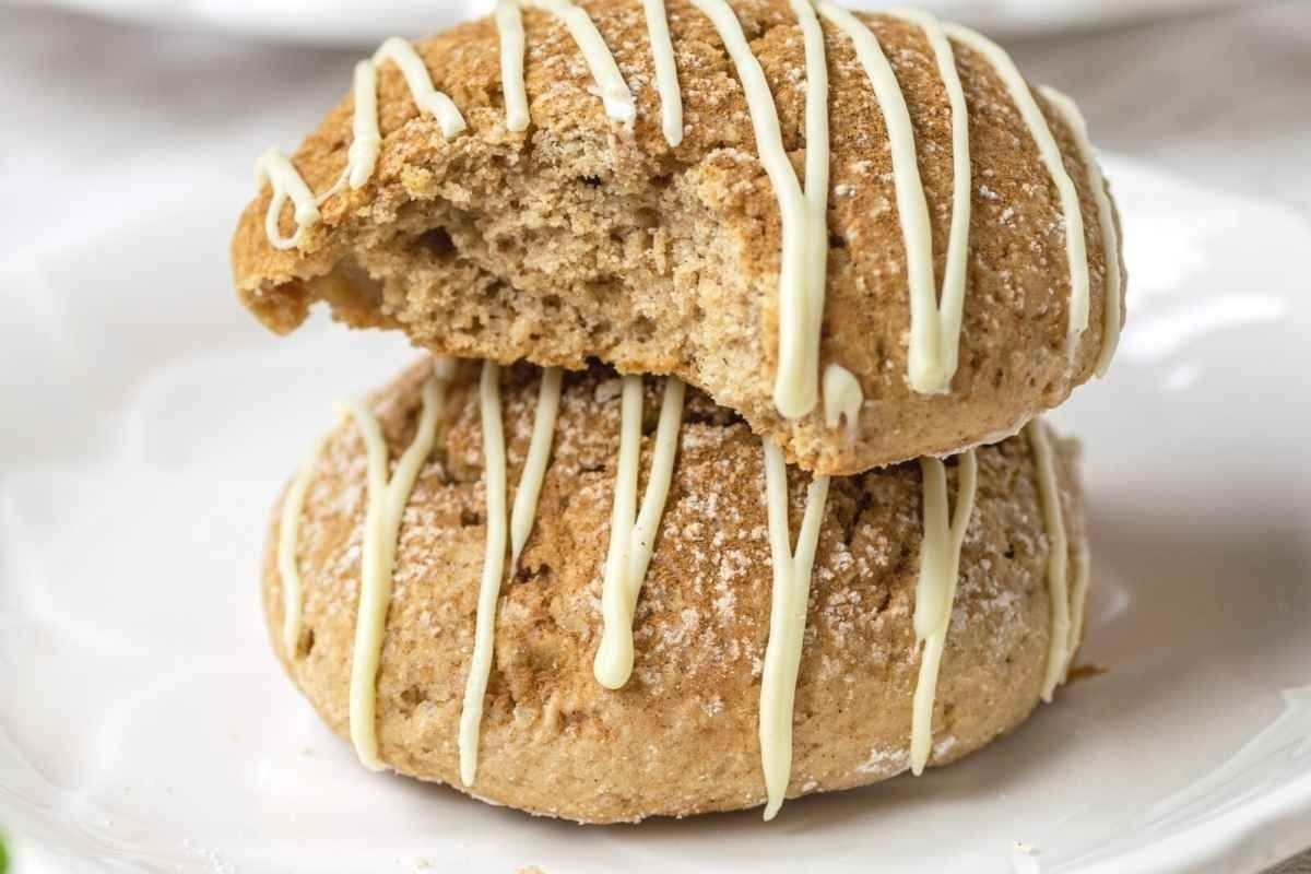 A plate with two cookies with icing on it.
