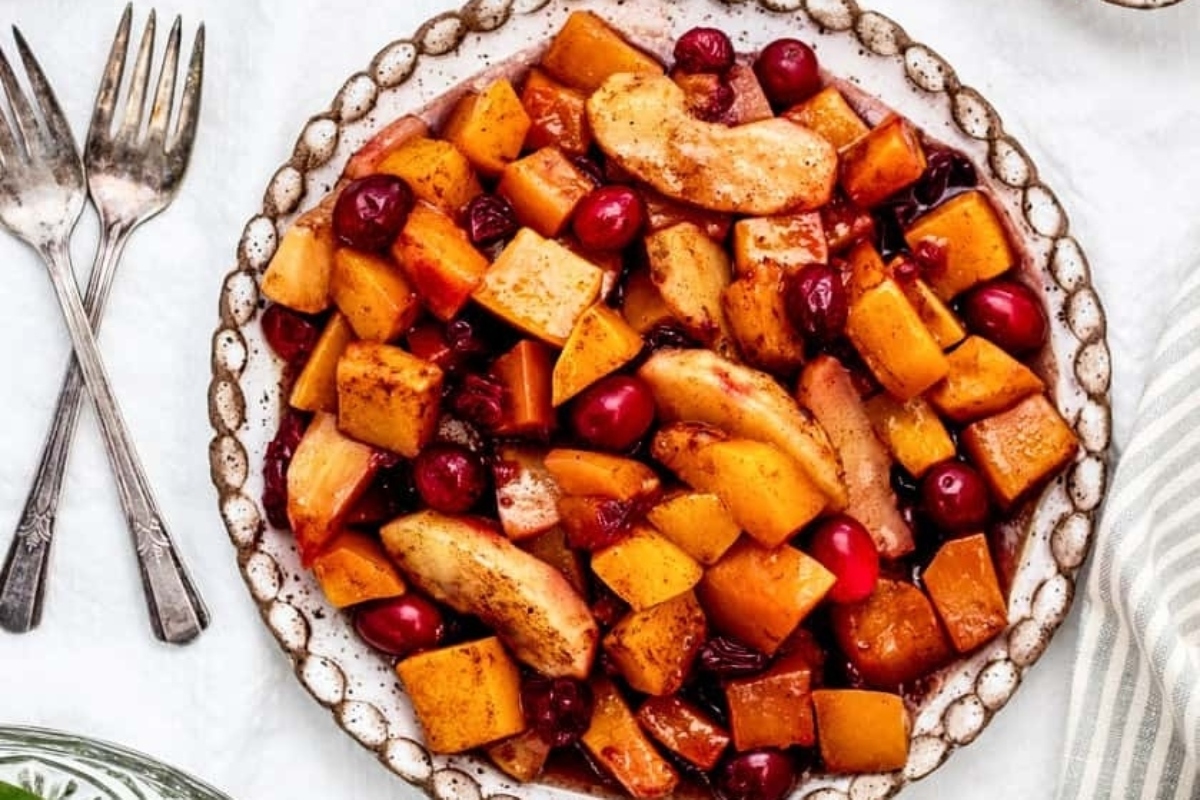A plate with cranberries and chicken on it.