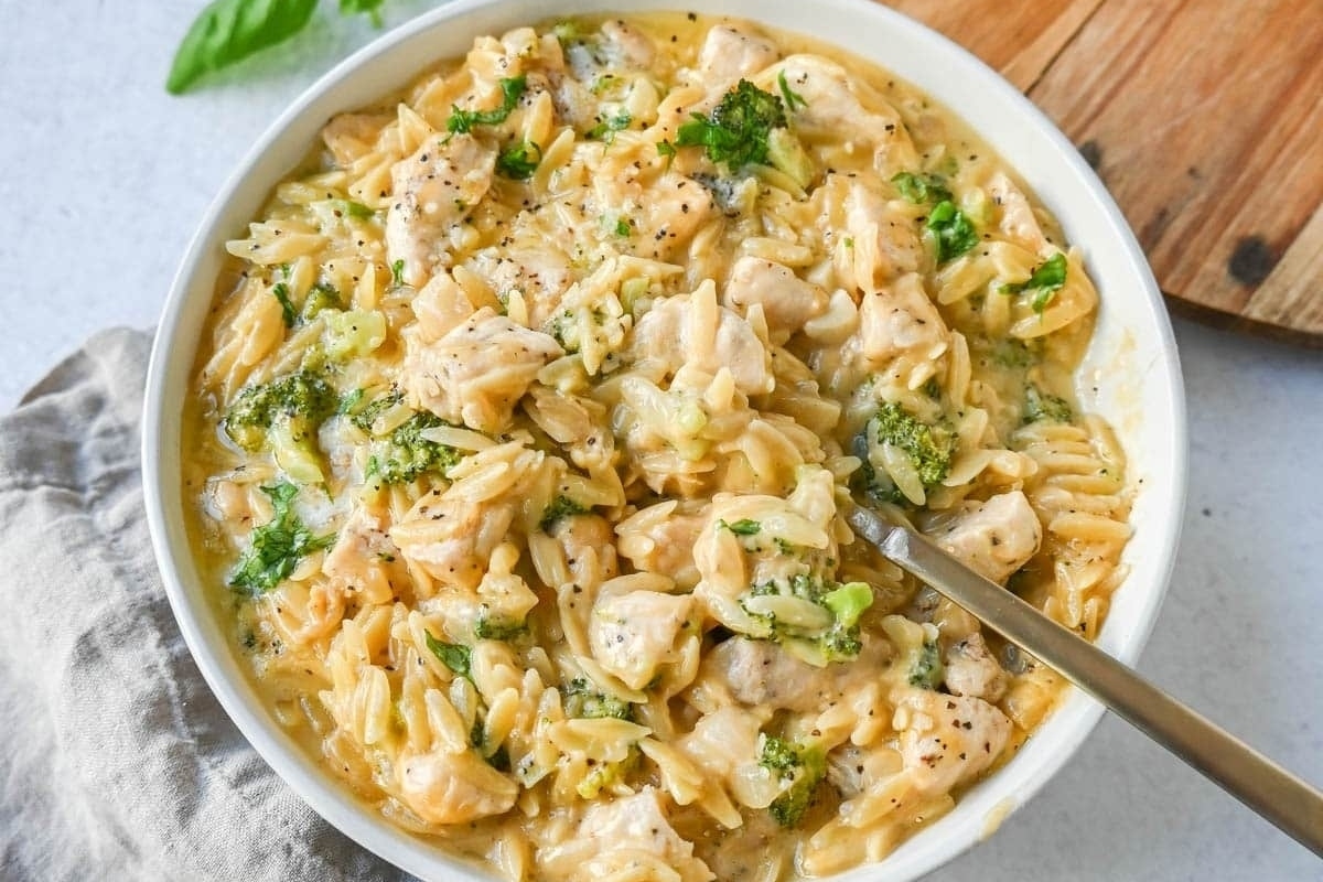 Chicken and pasta in a white bowl.