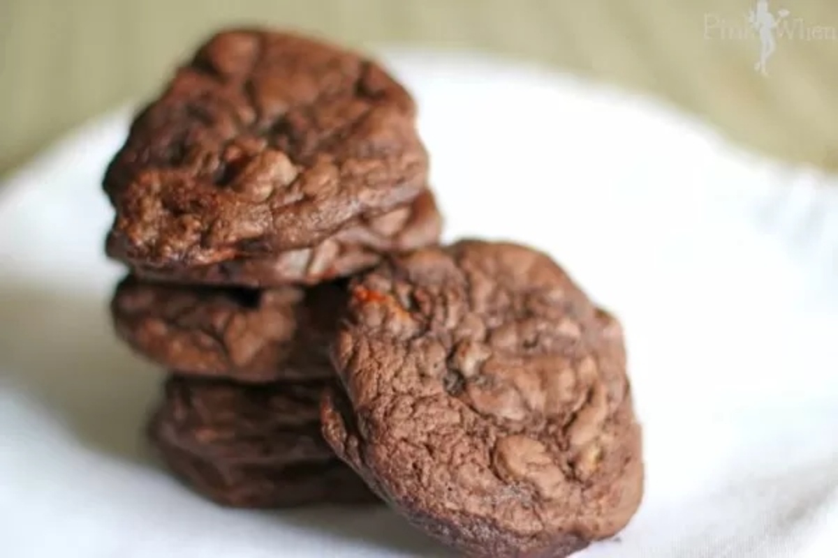 A stack of chocolate cookies on a white napkin.