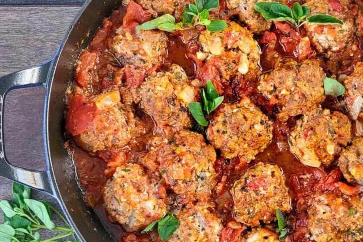 Meatballs in tomato sauce in a skillet.