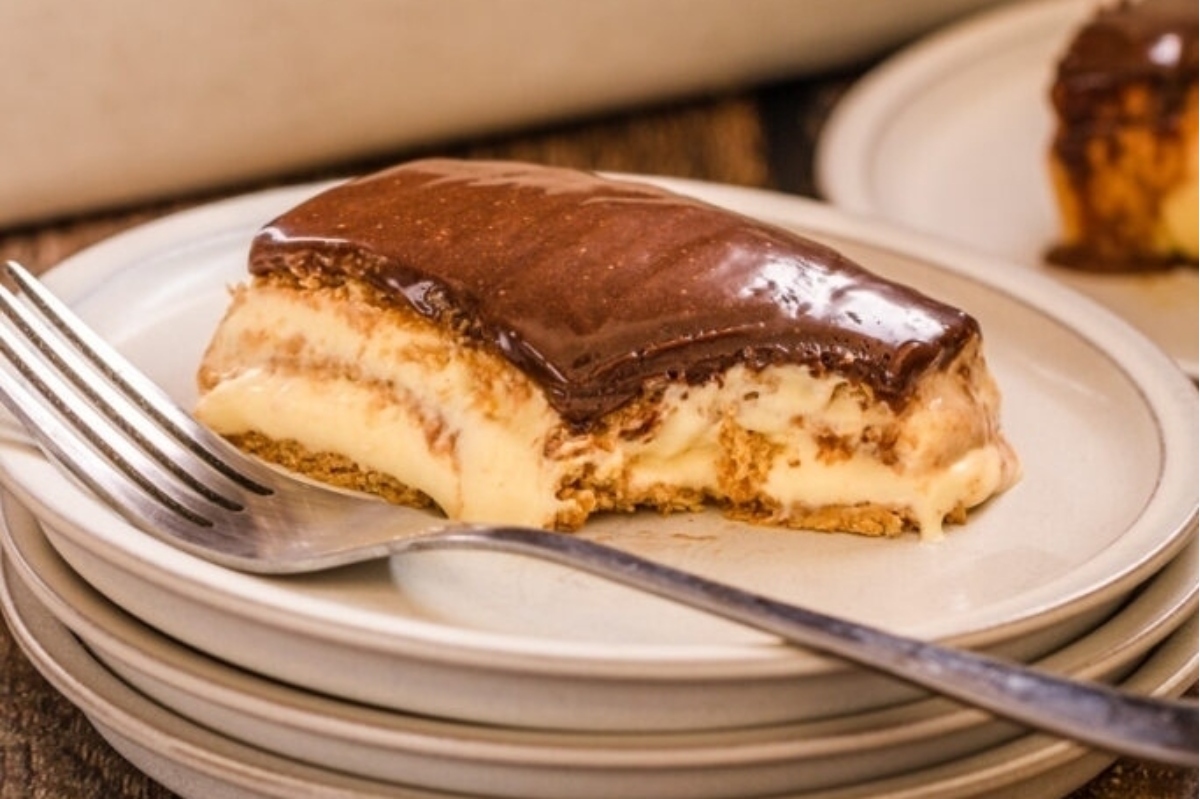 A slice of cheesecake on a plate with a fork.