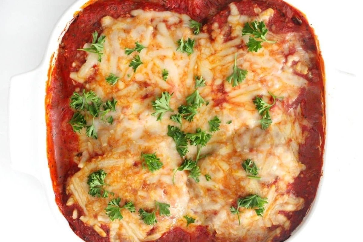 Eggplant parmesan in a white baking dish.