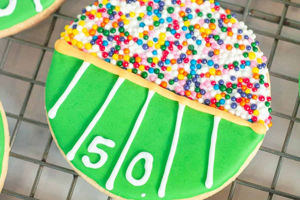Football cookies decorated with icing and sprinkles.