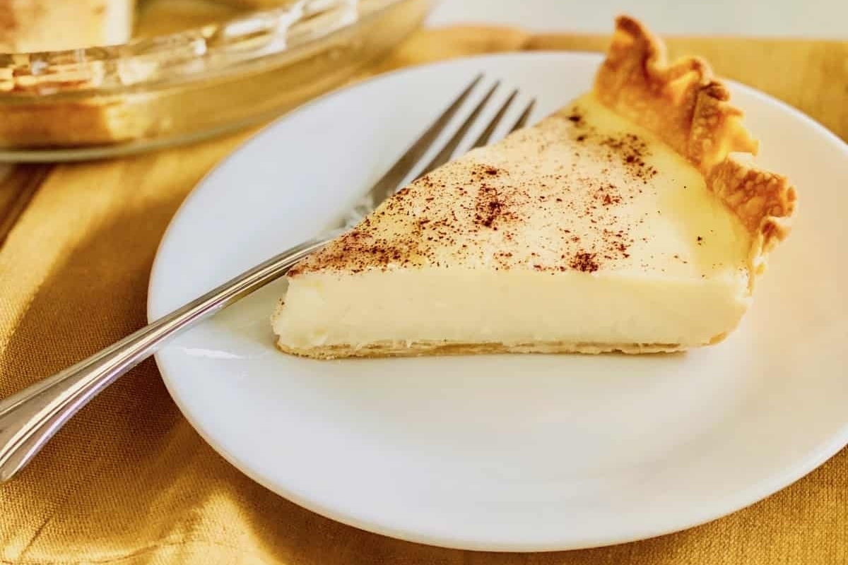 A slice of pie on a plate with a fork.