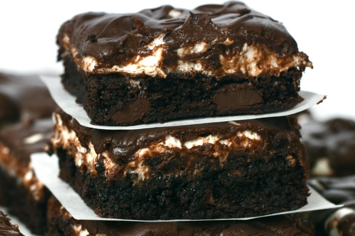 A stack of chocolate brownies stacked on top of each other.
