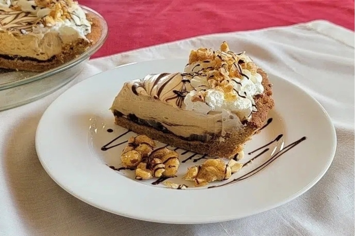 A slice of chocolate peanut butter pie on a plate.