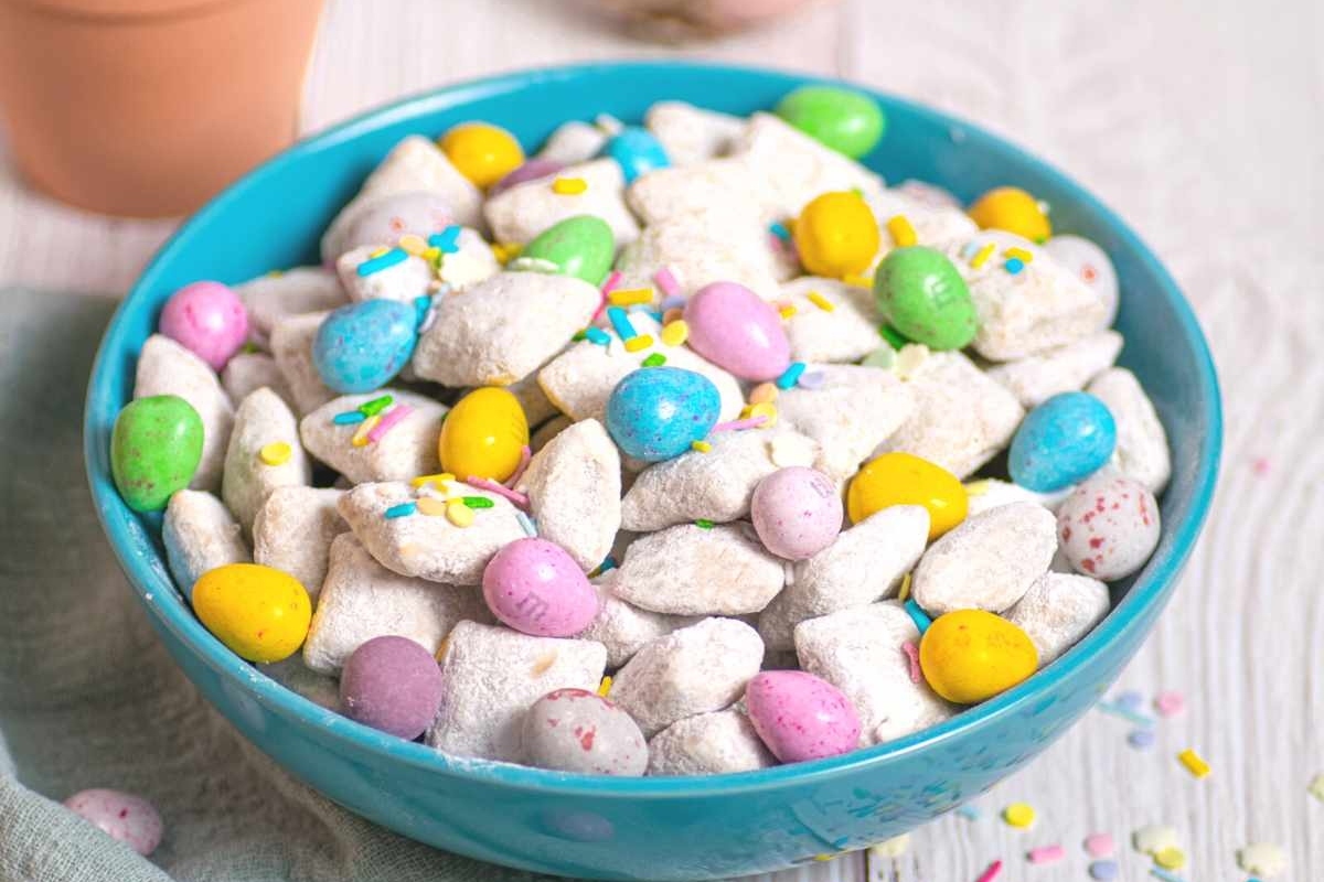 A blue bowl filled with easter candy.
