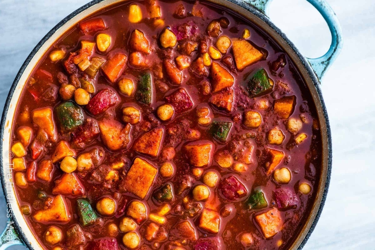 A pot of stew with vegetables and chickpeas.