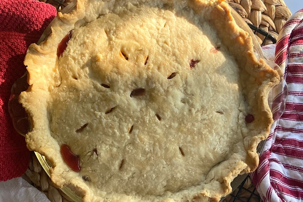 A pie is sitting on top of a wicker basket.