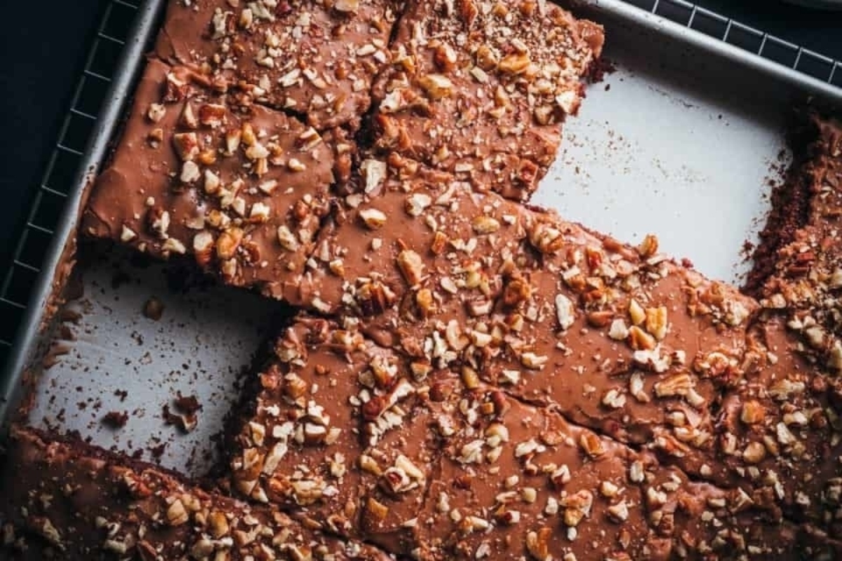A pan with brownies and nuts on it.