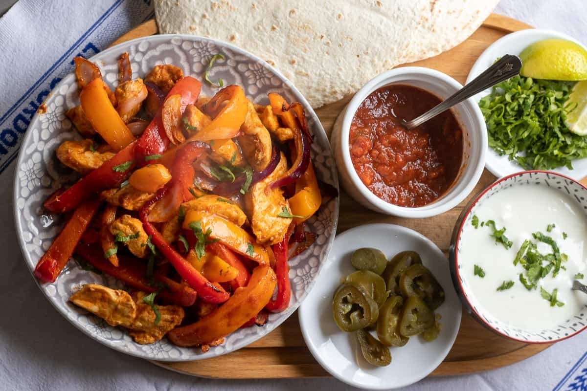 Chicken fajitas with guacamole and salsa.
