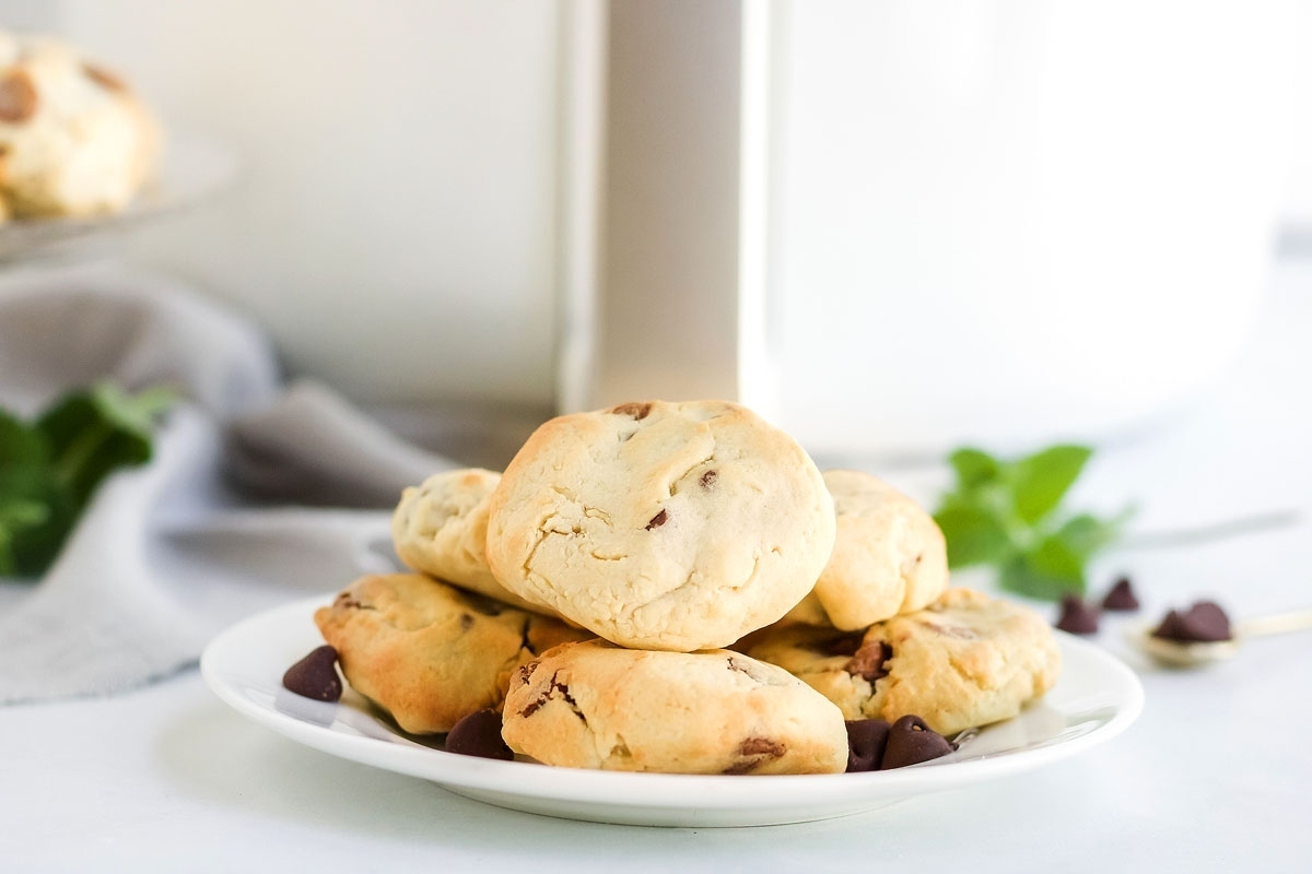 Chocolate chip cookies on a white plate.