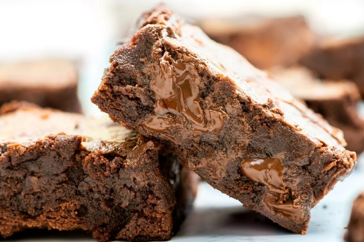 A stack of brownies with caramel on top.