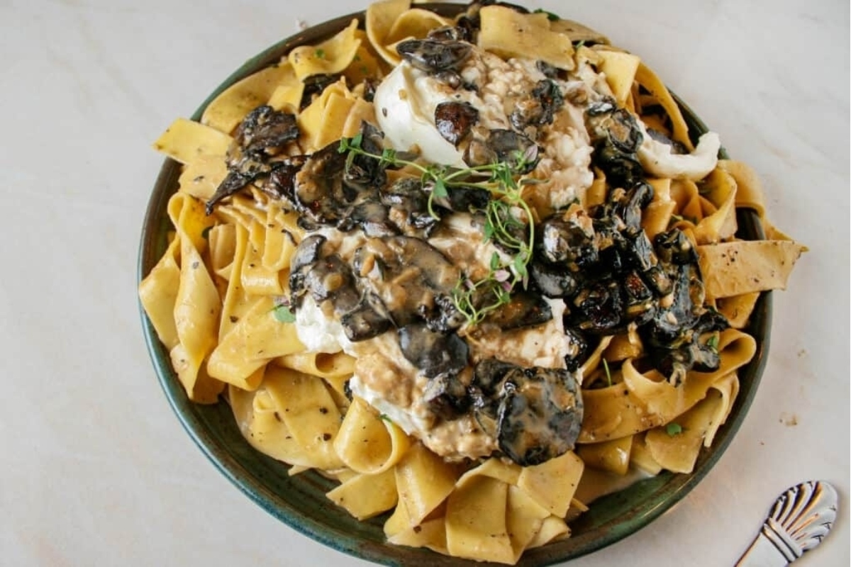 A plate of pasta with mushrooms and sage.