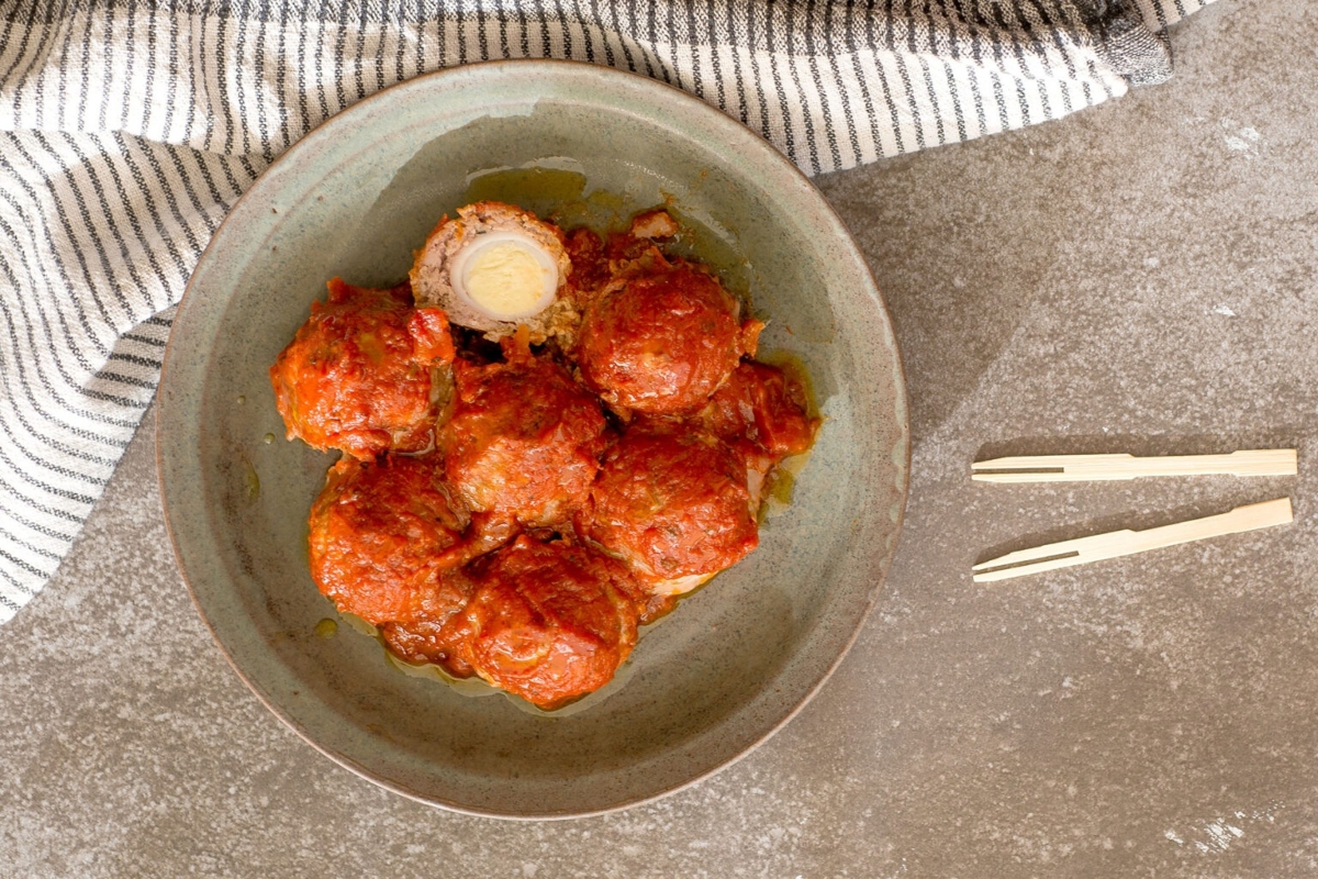 Meatballs in tomato sauce on a plate.