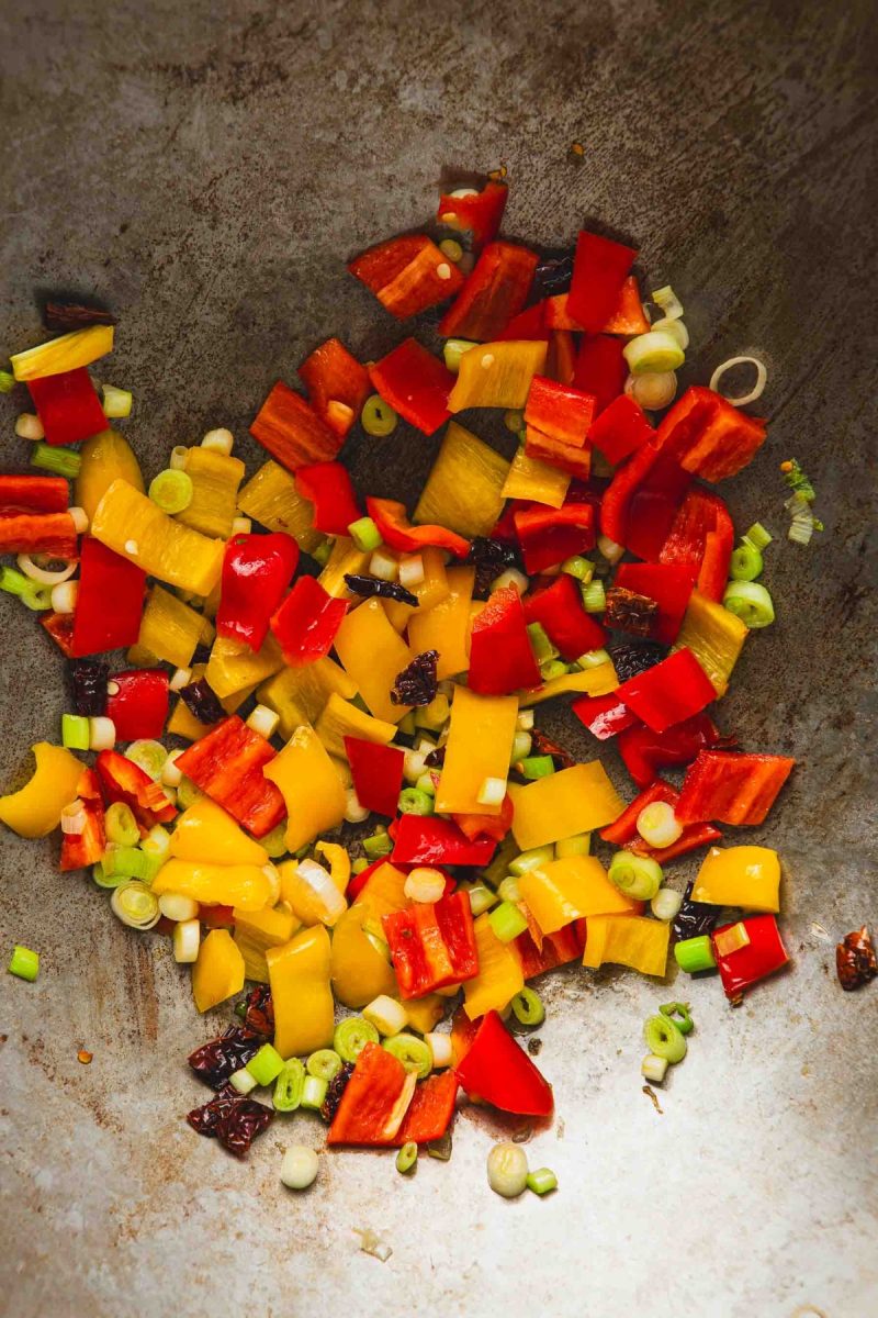 Kung pao beef with chopped peppers in a wok.